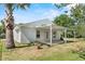 Back exterior featuring a covered patio and a well-maintained yard at 1103 W Dixie St, Plant City, FL 33563