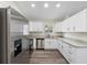 Bright kitchen featuring stainless steel appliances, white cabinets, and granite countertops at 1103 W Dixie St, Plant City, FL 33563