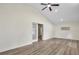 Cozy living room featuring wood-look floors, high ceilings, and natural light at 1103 W Dixie St, Plant City, FL 33563