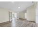 Open living room with wood-look floors, neutral paint, and natural light at 1103 W Dixie St, Plant City, FL 33563