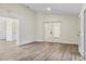 Inviting living room featuring wood-look flooring, neutral walls, and natural lighting at 1103 W Dixie St, Plant City, FL 33563