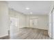 Open floor plan with stylish wood-look flooring, neutral walls, and natural lighting at 1103 W Dixie St, Plant City, FL 33563