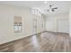 Bright living area with wood-look floors, ceiling fan, and access to the outdoors at 1103 W Dixie St, Plant City, FL 33563