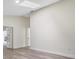 Spacious living room featuring modern wood-look flooring and neutral color scheme at 1103 W Dixie St, Plant City, FL 33563