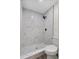 Modern shower with marble tile, a square rainfall showerhead, and pebble flooring at 1103 W Dixie St, Plant City, FL 33563