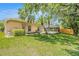 Expansive backyard with vibrant green lawn and a screened-in pool, perfect for outdoor activities at 11924 Northumberland Dr, Tampa, FL 33626