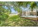 Lush backyard with green grass and a view of the screened-in pool, ideal for outdoor enjoyment at 11924 Northumberland Dr, Tampa, FL 33626