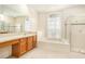 Bright bathroom features dual sinks, a soaking tub, and a glass-enclosed shower at 11924 Northumberland Dr, Tampa, FL 33626