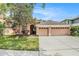 Charming one-story home with a well-manicured lawn and a two-car garage on a sunny day at 11924 Northumberland Dr, Tampa, FL 33626