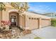 Inviting front entrance featuring a double-door entry and a two-car garage at 11924 Northumberland Dr, Tampa, FL 33626