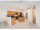 Open kitchen with wooden cabinets, granite countertops, and a tiled floor at 11924 Northumberland Dr, Tampa, FL 33626