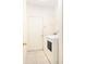Bright laundry room features a large washing machine, white walls, and tile flooring at 11924 Northumberland Dr, Tampa, FL 33626