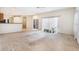 Spacious living room with sliding doors, plants and neutral carpet at 11924 Northumberland Dr, Tampa, FL 33626