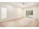 Bright living room featuring a ceiling fan and sliding glass doors to the pool at 11924 Northumberland Dr, Tampa, FL 33626