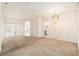 Spacious living room featuring neutral walls, carpeted floor, chandelier and arched doorways at 11924 Northumberland Dr, Tampa, FL 33626