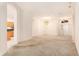 Bright living room boasts neutral walls, carpeted floor, chandelier, and arched doorways at 11924 Northumberland Dr, Tampa, FL 33626