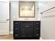 Bathroom featuring a dark vanity with modern hardware and a wooden-framed mirror at 4201 S Renellie Dr, Tampa, FL 33611