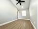 This bedroom features a ceiling fan, a window, and wood-look flooring at 4201 S Renellie Dr, Tampa, FL 33611
