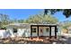 Inviting single-story home featuring a stylish front porch and beautifully landscaped flower beds at 4201 S Renellie Dr, Tampa, FL 33611