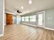 Bright living room with wood-look floors, stylish barn door, and abundant natural light at 4201 S Renellie Dr, Tampa, FL 33611