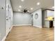 Bright, open-concept living area with modern flooring, a ceiling fan, and ample natural light at 4201 S Renellie Dr, Tampa, FL 33611