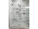 Close-up of modern shower with glass door, rainfall showerhead, and stylish marble-look tiling at 4201 S Renellie Dr, Tampa, FL 33611