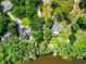 Aerial view of a property with mature trees and access to a body of water at 6317 Discovery Ln, Land O Lakes, FL 34638