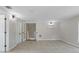 Large bonus room featuring light colored walls and neutral tile flooring with a staircase at 6317 Discovery Ln, Land O Lakes, FL 34638