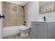Renovated bathroom with tiled bath/shower combo, modern vanity, and new fixtures and hardware at 6317 Discovery Ln, Land O Lakes, FL 34638