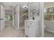 Bathroom featuring updated vanity, step-in shower, and serene window view at 6317 Discovery Ln, Land O Lakes, FL 34638