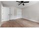 Light bedroom with wood flooring, ceiling fan, and double closets providing ample storage space at 6317 Discovery Ln, Land O Lakes, FL 34638