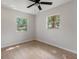 Bright bedroom with two windows, light walls and neutral flooring with a ceiling fan overhead at 6317 Discovery Ln, Land O Lakes, FL 34638