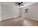 Bedroom with light walls and neutral flooring with a ceiling fan, window and light coming through at 6317 Discovery Ln, Land O Lakes, FL 34638