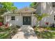 Inviting front entrance featuring double doors, lush landscaping, and a well-maintained walkway at 6317 Discovery Ln, Land O Lakes, FL 34638