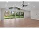 Sun-filled living room showcasing a vaulted ceiling and sliding glass doors to the yard at 6317 Discovery Ln, Land O Lakes, FL 34638