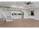 Open floorplan with staircase leading to upper floor and kitchen in the background at 6317 Discovery Ln, Land O Lakes, FL 34638