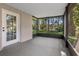 Screened-in patio with serene views of the backyard, mature trees and a body of water at 6317 Discovery Ln, Land O Lakes, FL 34638