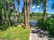Scenic view of the waterfront with a concrete path to the wooden dock at 6317 Discovery Ln, Land O Lakes, FL 34638
