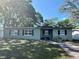 Inviting single-story home with a well-manicured lawn, traditional windows, and mature trees providing shade at 1808 Heather Ave, Tampa, FL 33612
