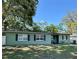 Charming single-story home featuring a well-maintained lawn, traditional windows with shutters, and mature shade trees at 1808 Heather Ave, Tampa, FL 33612