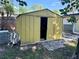 Exterior shot of a metal shed with an partially open door on a grass yard at 1808 Heather Ave, Tampa, FL 33612