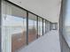 Long covered balcony with sliding glass doors, a great view, and black railing at 3211 W Swann Ave # 911, Tampa, FL 33609