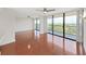 Bright living room featuring hardwood floors, ceiling fans and access to private balconies at 3211 W Swann Ave # 911, Tampa, FL 33609