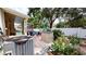 Landscaped backyard featuring a small storage shed, AC, and outdoor seating area at 4506 Gentrice Dr, Valrico, FL 33596