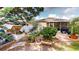 Backyard with garden plot, patio, seating and a manicured lawn at 4506 Gentrice Dr, Valrico, FL 33596