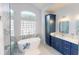 Bright bathroom featuring a soaking tub, dual sinks, and custom cabinetry at 4506 Gentrice Dr, Valrico, FL 33596