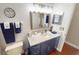 Bathroom featuring a navy vanity, granite countertops, modern lighting, and updated fixtures at 4506 Gentrice Dr, Valrico, FL 33596