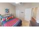 Charming bedroom featuring carpet floors, a bed with red, white and blue bedding and bright natural light at 4506 Gentrice Dr, Valrico, FL 33596