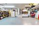 Well-lit garage with white cabinets, a workbench, and additional refrigerator offering ample storage and functionality at 4506 Gentrice Dr, Valrico, FL 33596