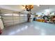 A functional garage area with a workbench and multiple storage units, under bright overhead lights, for organization at 4506 Gentrice Dr, Valrico, FL 33596